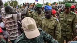 Niger's National Concil for the sefeguard of the Homeland (CNSP) Colonel-Major Amadou Abdramane (C), General Mohamed Toumba (C-L) and Colonel Ousmane Abarchi (R) are greeted by supporters upon their arrives at the Stade General Seyni Kountche in Niamey Niger on August 6, 2023. Thousands of supporters of the military coup in Niger gathered at a Niamey stadium Sunday, when a deadline set by the West African regional bloc ECOWAS to return the deposed President Mohamed Bazoum to power is set to expire, according to AFP journalists. A delegation of members of the ruling National Council for the Safeguard of the Homeland (CNSP) arrived at the 30,000-seat stadium to cheers from supporters, many of whom were drapped in Russian flags and portraits of CNSP leaders. (Photo by AFP) (Photo by -/AFP via Getty Images)